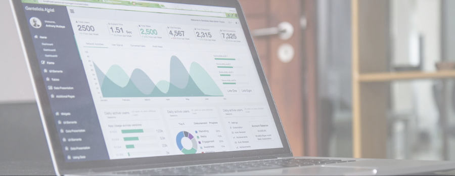 A computer on a desk displays graphs of data to measure marketing effectiveness